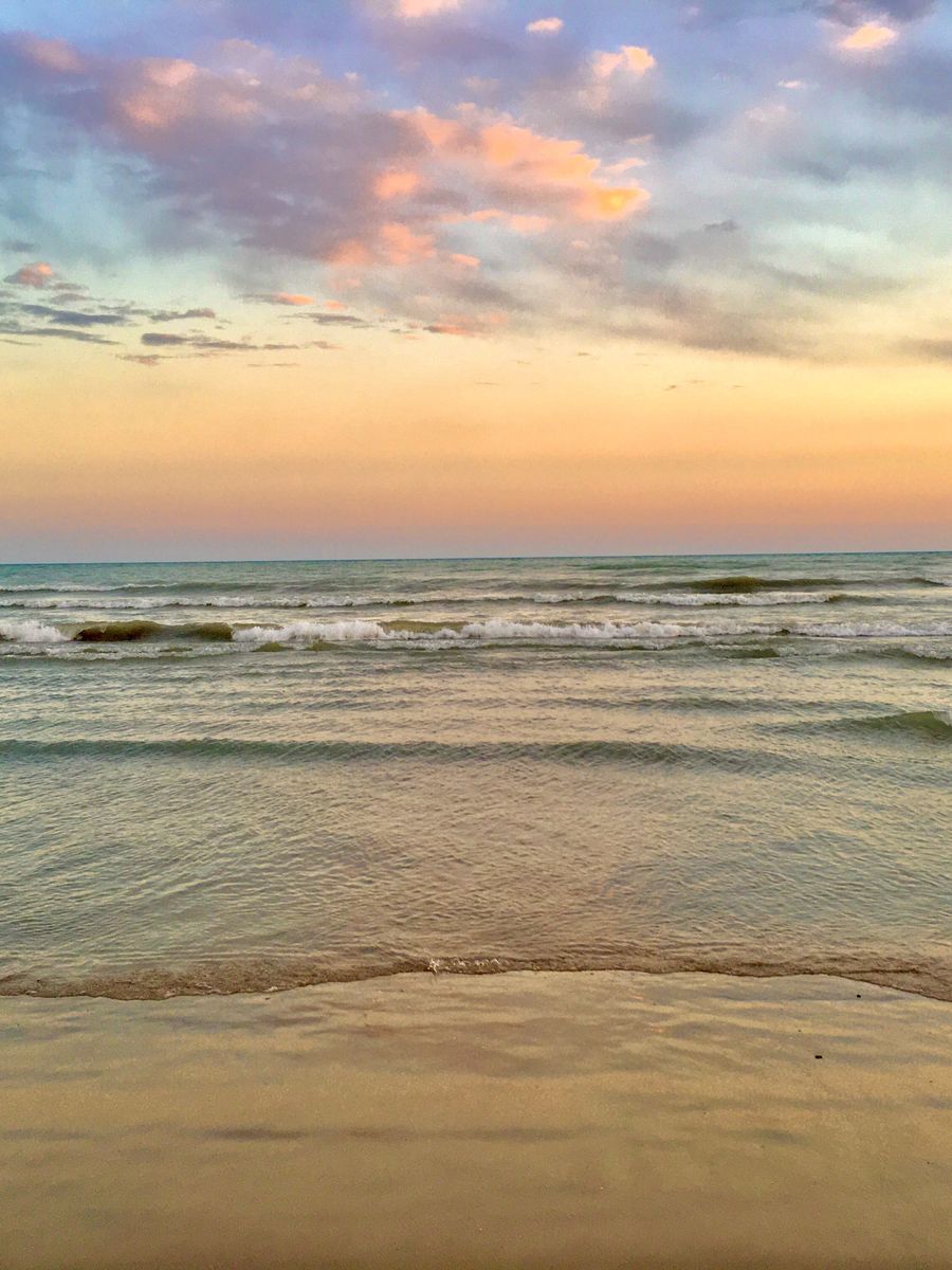 Sunset over the waves at Victoria Park Beach in Cobourg