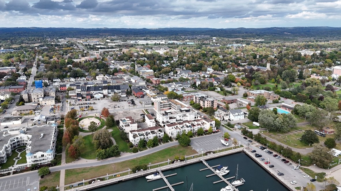 Aerial view of downtown Cobourg in autumn, with the harbour in the corner