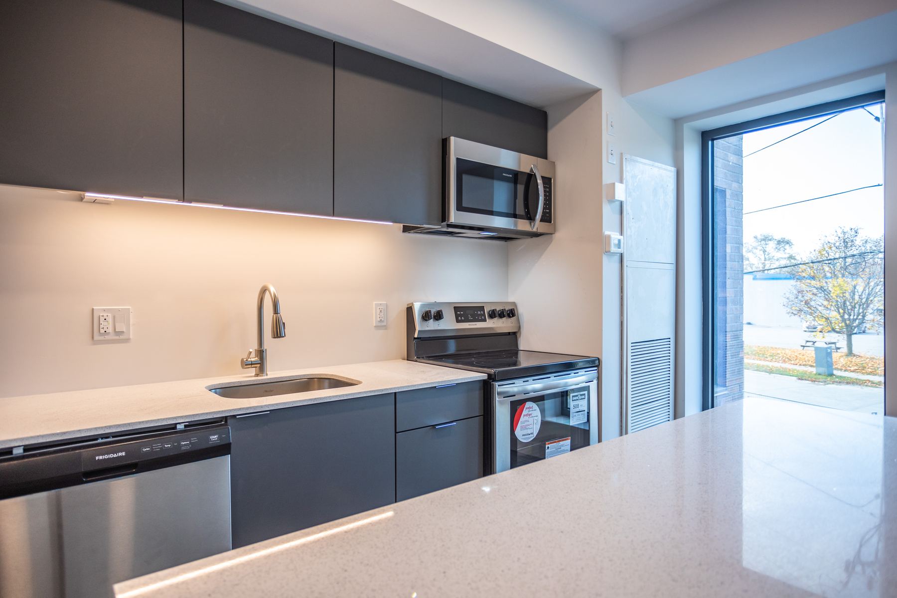 Kitchen with stainless steel appliances and under-cabinet lighting